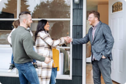 Couple shaking hands with broker